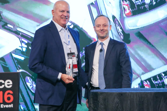 Consumer Portfolio Services Chief Executive Charles Bradley Jr. (L) accepts the 2016 Auto Finance Excellence Award, presented by JJ Hornblass, president and CEO of Royal Media Group.