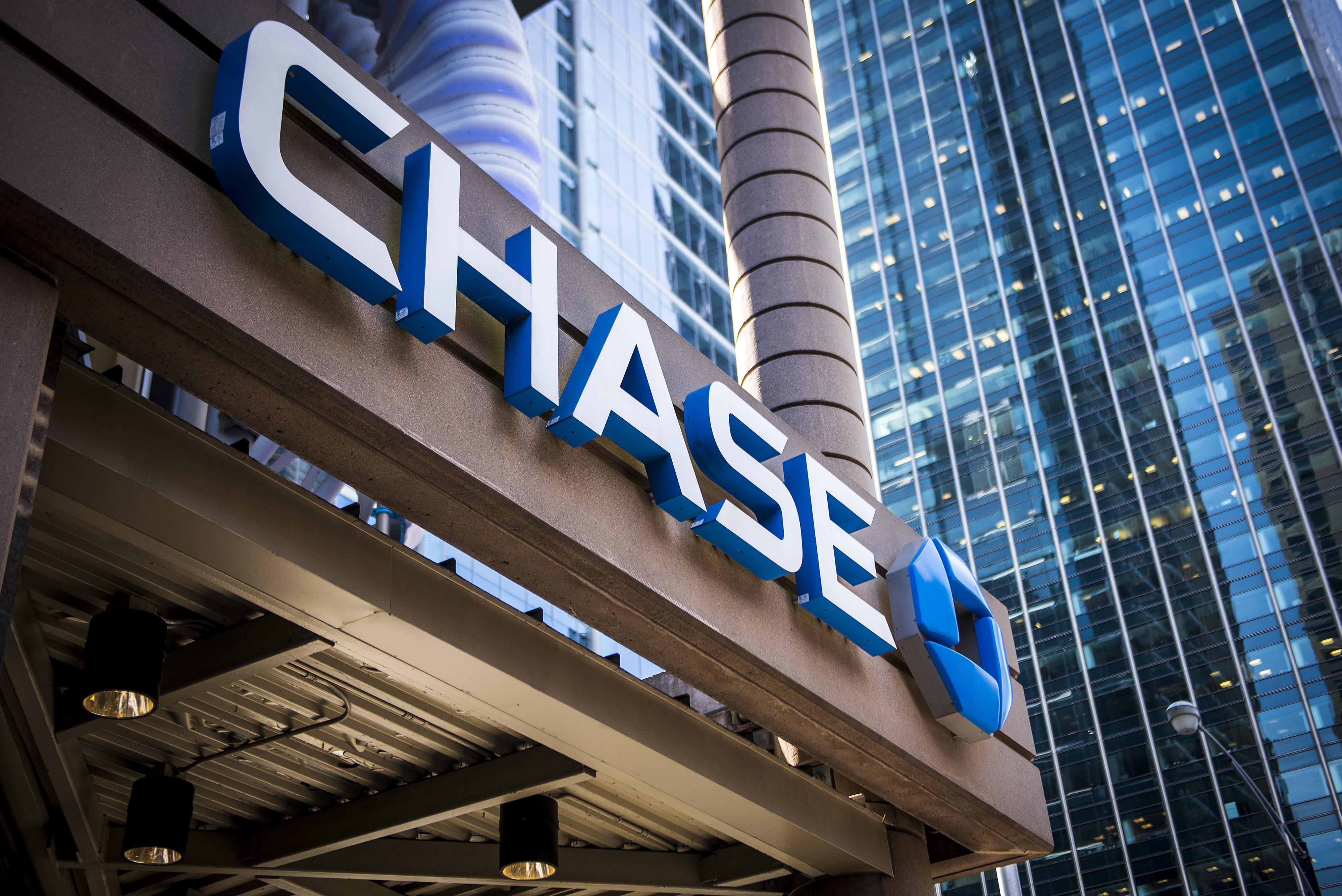 Signage is displayed outside a JPMorgan Chase & Co. bank branch stands in Chicago, Illinois, U.S., on Tuesday, July 10, 2017. JPMorgan Chase & Co. is scheduled to release earnings figures on July 13. Photographer: Christopher Dilts/Bloomberg