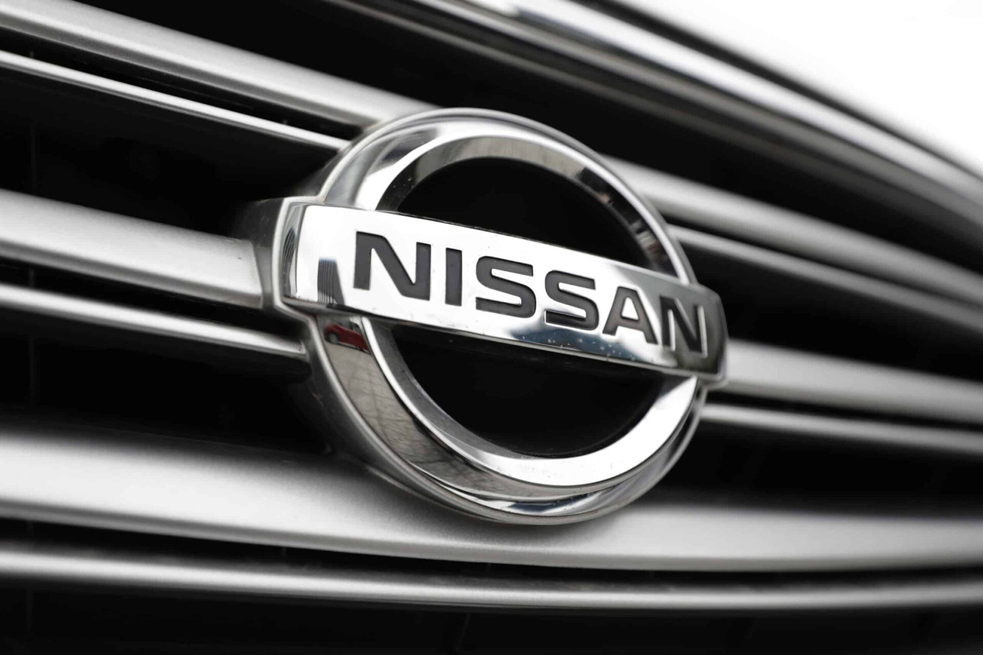 close up of nissan logo on vehicle