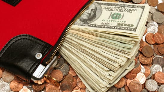 money in wallet on coins, debt concept