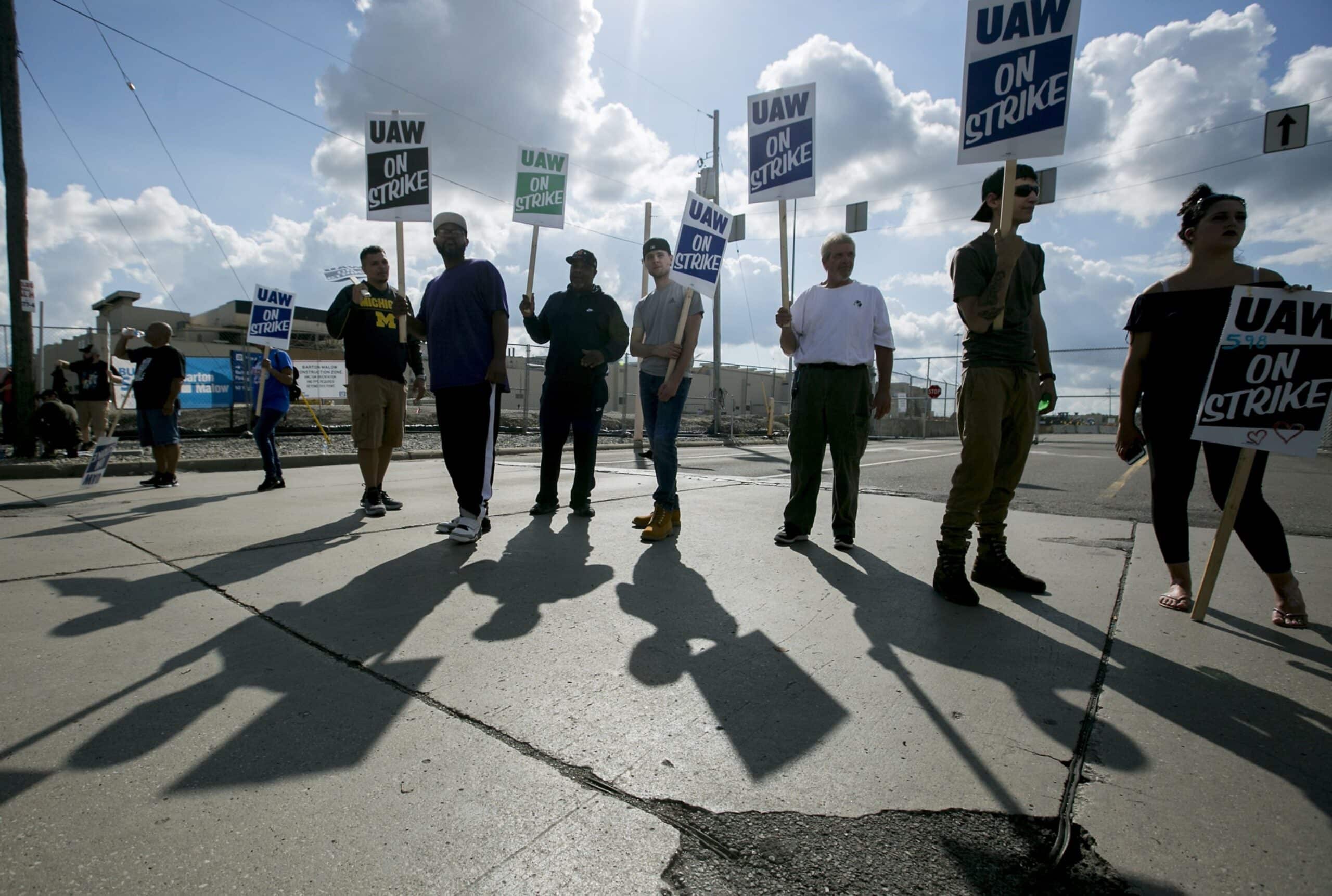 Demonstrators holds signs reading "UAW On Strike" during a United Auto Workers (UAW) strike outside the General Motors Co. Flint Assembly plant in Flint, Michigan, U.S., on Monday, Sept. 16, 2019. The UAW union is leading its first strike against General Motors in 12 years, digging in for a fight over jobs and benefits that could cost the carmaker dearly for an indefinite period. Photographer: Anthony Lanzilote/Bloomberg