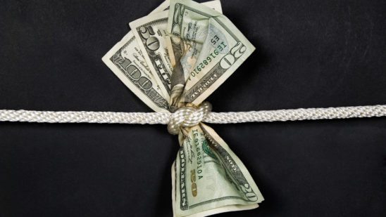 money tied with rope - squeezed
