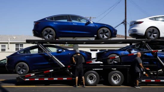 Tesla tops $900 in parabolic surge, spurring downgrade
