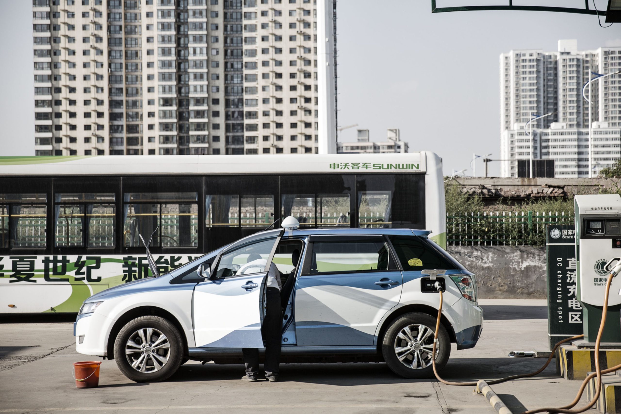 A BYD Co. E6 electric taxi stands plugged to a charger at a State Grid Corp. of China charging station in Taiyuan, Shanxi province, China, on Tuesday, Sept. 13, 2016. Taiyuan became the first city to replace its entire fleet of taxis with electric vehicles. Photographer: Qilai Shen/Bloomberg