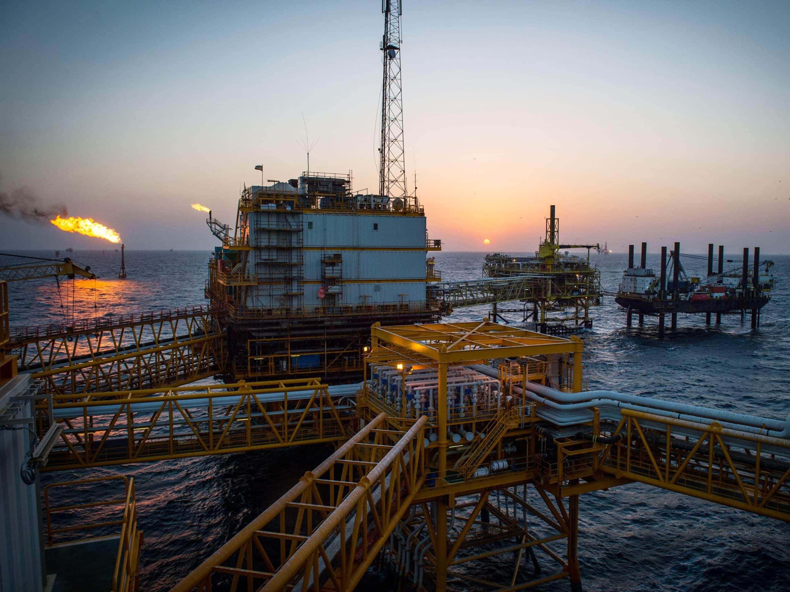 Gas flares burn from pipes aboard an offshore oil platform in the Persian Gulf's Salman Oil Field, operated by the National Iranian Offshore Oil Co., near Lavan island, Iran, on Thursday, Jan. 5. 2017. Nov. 5 is the day when sweeping U.S. sanctions on Irans energy and banking sectors go back into effect after Trumps decision in May to walk away from the six-nation deal with Iran that suspended them. Photographer: Ali Mohammadi/Bloomberg