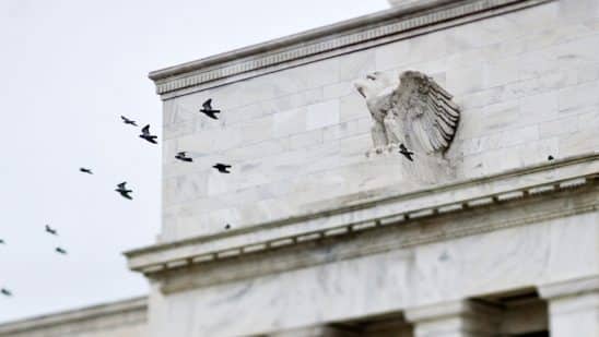 Birds fly past the Marriner S. Eccles Federal Reserve Board building in Washington, D.C.