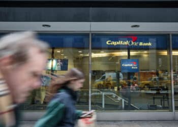 capital one atm with people moving past