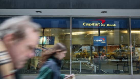 capital one atm with people moving past