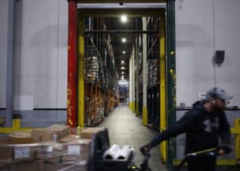 A worker drives a forklift through a grocery distribution center in Louisville, Kentucky. Photographer: Luke Sharrett/Bloomberg