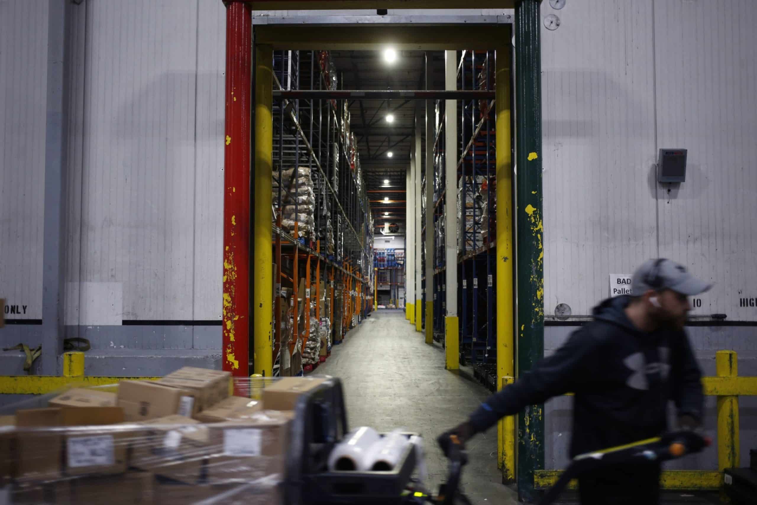 A worker drives a forklift through a grocery distribution center in Louisville, Kentucky. Photographer: Luke Sharrett/Bloomberg