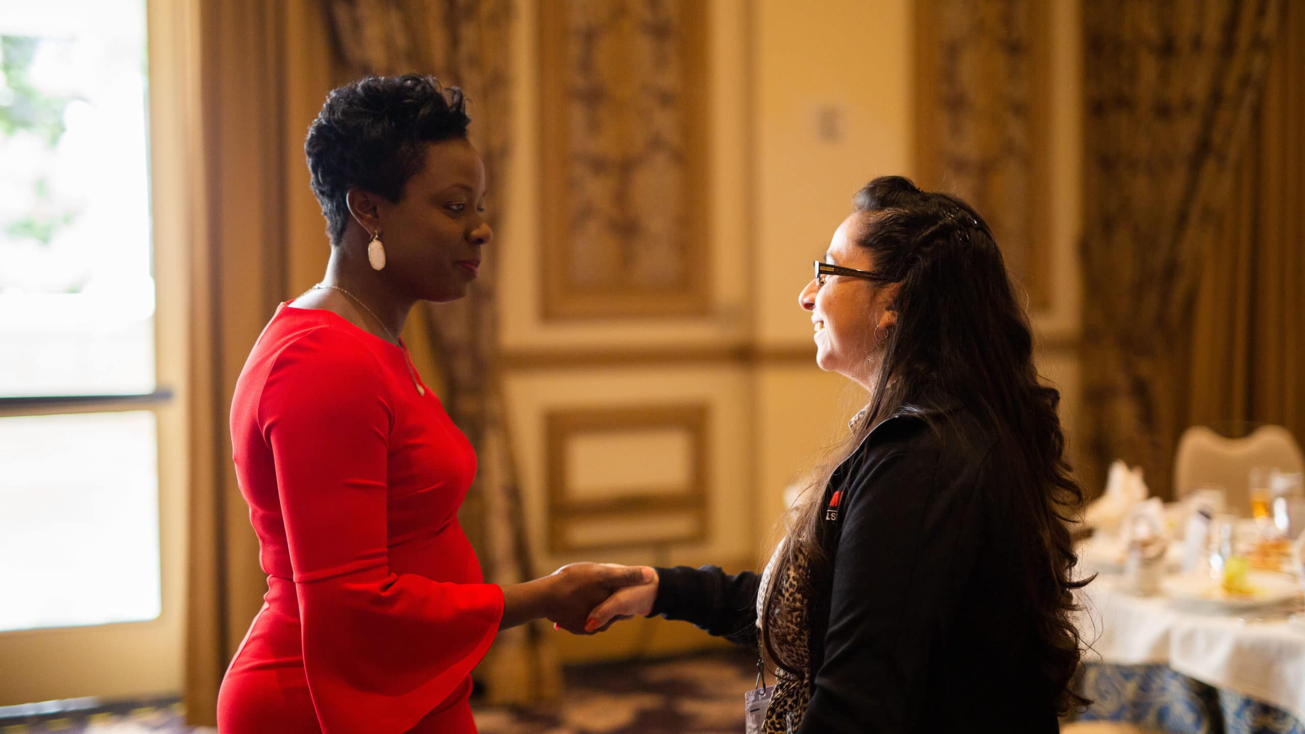 Renee Horne, vice president of consumer lending experiences, meets with an attendee at the 2019 Auto Finance Summit after her presentation at the Women in Auto Finance Luncheon