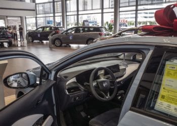 car in dealership showroom with bow on top