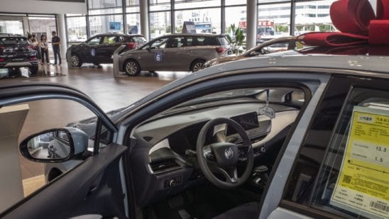 car in dealership showroom with bow on top
