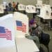 Voters wearing protective masks cast ballots at a polling location for the 2020 Presidential election in Des Moines, Iowa, U.S., on Tuesday, Nov. 3, 2020. American voters, at least those who've not yet cast ballots, go to the polls Tuesday to choose between President Donald Trump and Democratic nominee Joe Biden and cast votes in U.S. House and Senate races and state and local elections. Photographer: Rachel Mummey/Bloomberg