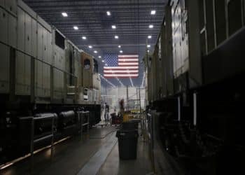 An American flag hangs at a factory in Fort Worth, Texas. Photographer: Luke Sharrett/Bloomberg