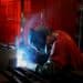 A worker welds a lawnmower frame together on the assembly line at a facility in Coatesville, Indiana. Photographer: Luke Sharrett/Bloomberg