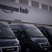 Delivery vans parked outside the package pick-up and returns area of an Amazon fulfillment center in Denver, Colorado.