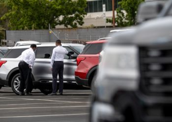 Customers view a vehicle for sale at a Ford Motor Co. dealership in Richmond, California, U.S., on Thursday, July 1, 2021. The global semiconductor shortage that hobbled auto production worldwide this year is leaving showrooms with few models to showcase just as U.S. consumers breaking free of pandemic restrictions are eager for new wheels.