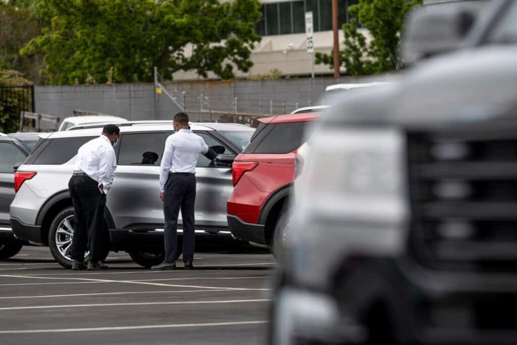 Customers view a vehicle for sale at a Ford Motor Co. dealership in Richmond, California, U.S., on Thursday, July 1, 2021. The global semiconductor shortage that hobbled auto production worldwide this year is leaving showrooms with few models to showcase just as U.S. consumers breaking free of pandemic restrictions are eager for new wheels.