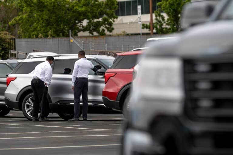 Customers view a vehicle for sale at a Ford Motor Co. dealership in Richmond, California, U.S., on Thursday, July 1, 2021. The global semiconductor shortage that hobbled auto production worldwide this year is leaving showrooms with few models to showcase just as U.S. consumers breaking free of pandemic restrictions are eager for new wheels.