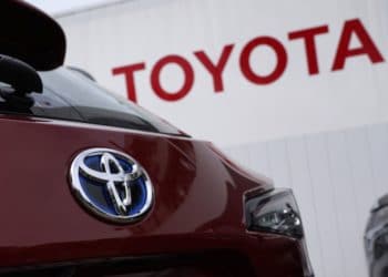 A Toyota Motor Co. badge is seen on a Corolla Touring wagon displayed outside a dealership in Tokyo, Japan, on Sunday, May 10, 2020. Global automakers and suppliers are on track to get at least $100 billion of bank financing as the coronavirus pandemic hammers car sales. Photographer: Toru Hanai/Bloomberg