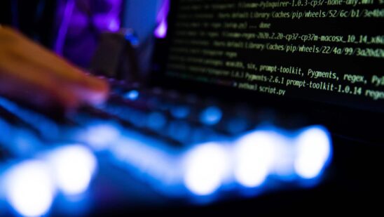 Computer code and text displayed on computer screens