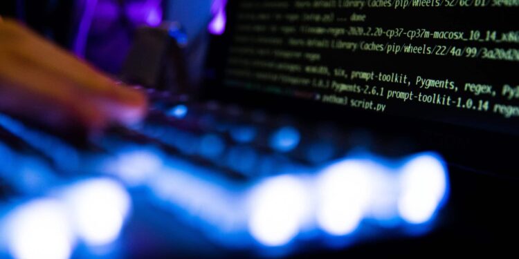 Computer code and text displayed on computer screens