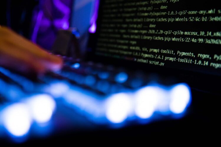 Computer code and text displayed on computer screens