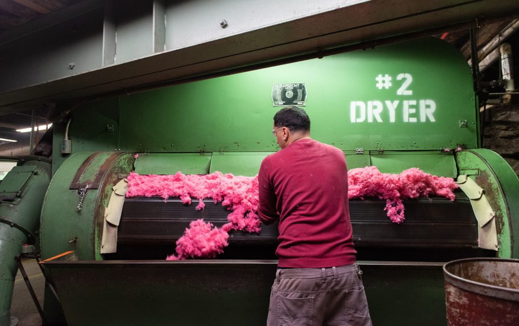 A worker checks dried dyed fiber at a raw stock dye house in Philadelphia, Pennsylvania.