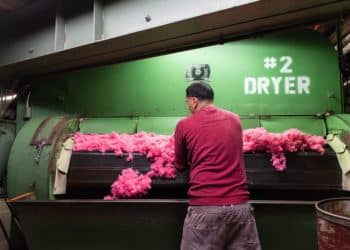 A worker checks dried dyed fiber at a raw stock dye house in Philadelphia, Pennsylvania.