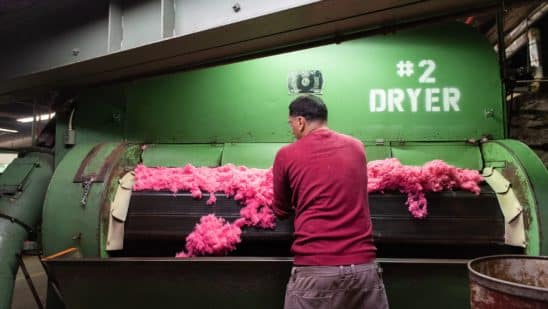 A worker checks dried dyed fiber at a raw stock dye house in Philadelphia, Pennsylvania.