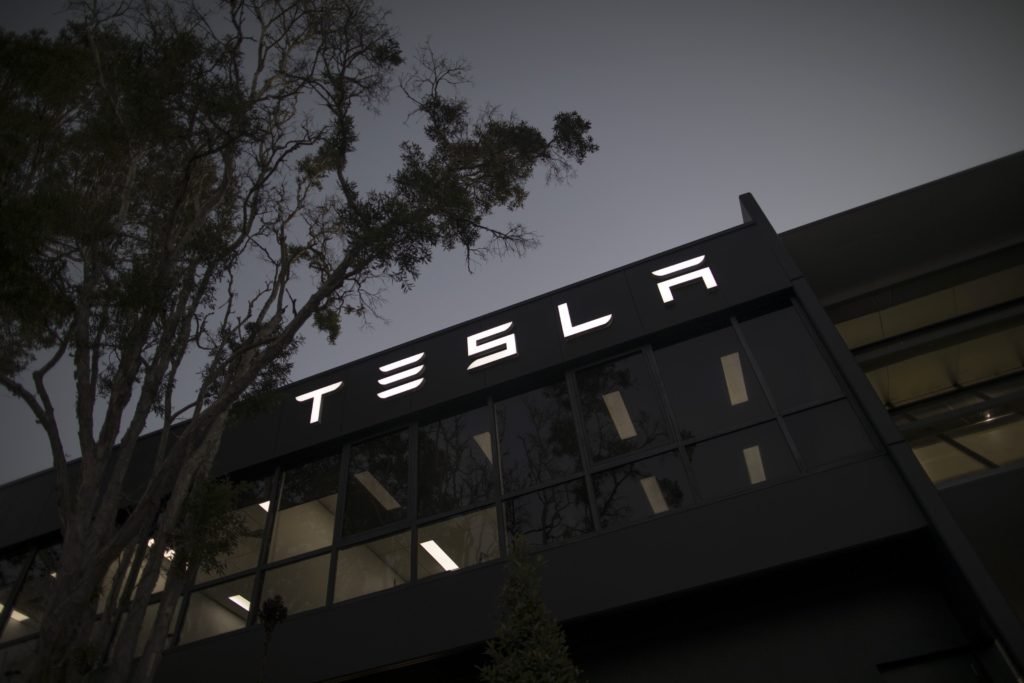 Signage at a Tesla Inc. showroom and service center in Sydney, Australia, on Monday, April 12, 2021. Tesla and the electric-car industry generally thrive in the worlds richest nations. Not so in Australia, where even tractors outsell EVs two to one.