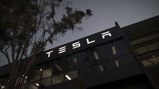 Signage at a Tesla Inc. showroom and service center in Sydney, Australia, on Monday, April 12, 2021. Tesla and the electric-car industry generally thrive in the worlds richest nations. Not so in Australia, where even tractors outsell EVs two to one.