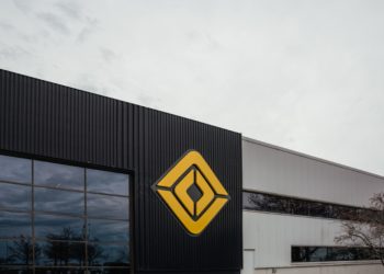A logo outside the Rivian manufacturing facility in Normal, Illinois, US., on Monday, April 11, 2022. Rivian Automotive Inc. produced 2,553 vehicles in the first quarter as the maker of plug-in trucks contended with a snarled supply chain and pandemic challenges.