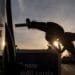 A driver holds a fuel nozzle at a gas station in Sacramento, California.