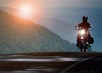 Man riding motorcycle on mountain highway