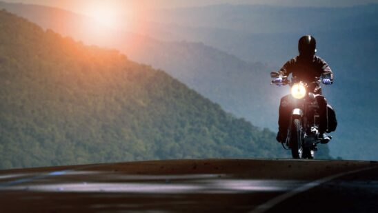 Man riding motorcycle on mountain highway