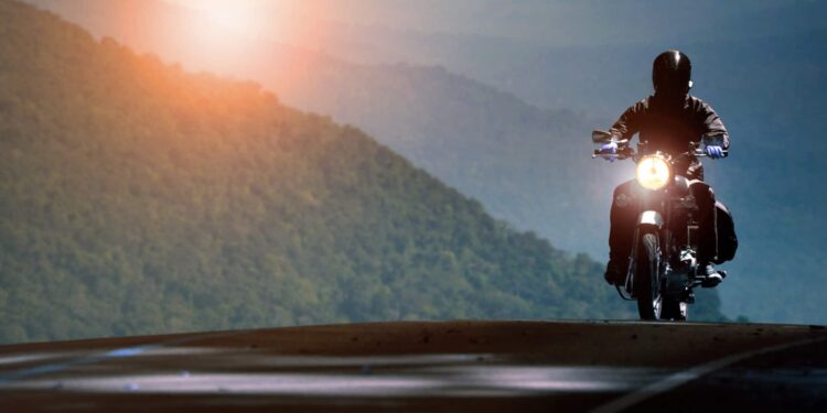 Man riding motorcycle on mountain highway
