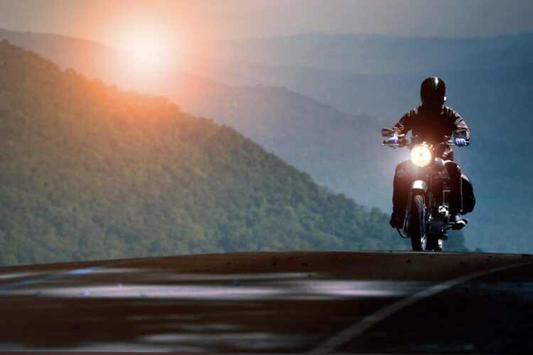 Man riding motorcycle on mountain highway