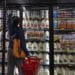 A shopper reaches for cottage cheese inside a grocery store in San Francisco, California, U.S., on Monday, May 2, 2022. U.S. inflation-adjusted consumer spending rose in March despite intense price pressures, indicating households still have solid appetites and wherewithal for shopping.