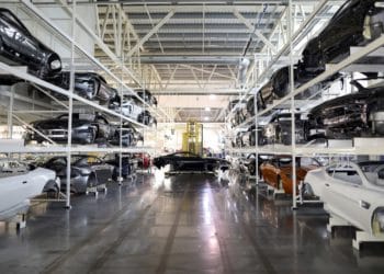 The painted bodywork of an Aston Martin DB11 luxury automobile is moved by a robot through the Aston Martin Lagonda Ltd.'s manufacturing and assembly plant in Gaydon, U.K., on Tuesday, June 6, 2017. Aston Martin may consider an initial public offering as early as next year as the British maker of James Bonds cars seeks to capitalize on the success of Ferrari NVs listing to lure investors, people familiar with the matter said.