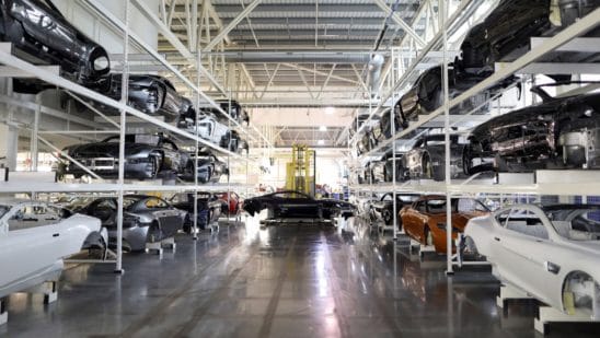 The painted bodywork of an Aston Martin DB11 luxury automobile is moved by a robot through the Aston Martin Lagonda Ltd.'s manufacturing and assembly plant in Gaydon, U.K., on Tuesday, June 6, 2017. Aston Martin may consider an initial public offering as early as next year as the British maker of James Bonds cars seeks to capitalize on the success of Ferrari NVs listing to lure investors, people familiar with the matter said.