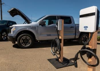 A Ford Lightning F-150 pickup truck next to a charging station during a media event at Vino Farms in Healdsburg, California, US, on Friday, May 20, 2022. With the release of the F-150 Lightning, Ford hopes to electrify new and traditional truck buyers alike, and eventually to replace its industry-defining gas-powered line. Photographer: David Paul Morris/Bloomberg