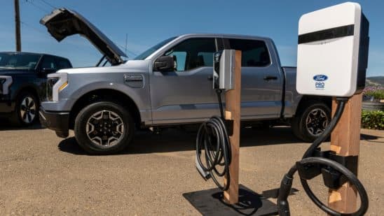 A Ford Lightning F-150 pickup truck next to a charging station during a media event at Vino Farms in Healdsburg, California, US, on Friday, May 20, 2022. With the release of the F-150 Lightning, Ford hopes to electrify new and traditional truck buyers alike, and eventually to replace its industry-defining gas-powered line. Photographer: David Paul Morris/Bloomberg