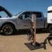 A Ford Lightning F-150 pickup truck next to a charging station during a media event at Vino Farms in Healdsburg, California, US, on Friday, May 20, 2022. With the release of the F-150 Lightning, Ford hopes to electrify new and traditional truck buyers alike, and eventually to replace its industry-defining gas-powered line. Photographer: David Paul Morris/Bloomberg