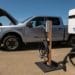 A Ford Lightning F-150 pickup truck next to a charging station during a media event at Vino Farms in Healdsburg, California, US, on Friday, May 20, 2022. With the release of the F-150 Lightning, Ford hopes to electrify new and traditional truck buyers alike, and eventually to replace its industry-defining gas-powered line. Photographer: David Paul Morris/Bloomberg