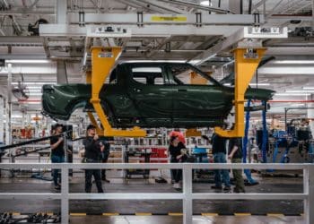 Workers assembly components of a Rivian R1T electric vehicle (EV) pickup truck at the company's manufacturing facility in Normal, Illinois, US., on Monday, April 11, 2022. Rivian Automotive Inc. produced 2,553 vehicles in the first quarter as the maker of plug-in trucks contended with a snarled supply chain and pandemic challenges.