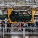 Workers assembly components of a Rivian R1T electric vehicle (EV) pickup truck at the company's manufacturing facility in Normal, Illinois, US., on Monday, April 11, 2022. Rivian Automotive Inc. produced 2,553 vehicles in the first quarter as the maker of plug-in trucks contended with a snarled supply chain and pandemic challenges.