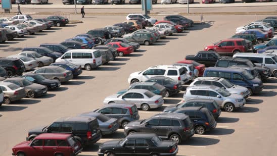 cars lined up in parking lot aerial view