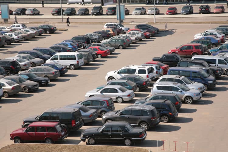 cars lined up in parking lot aerial view